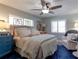 Cozy main bedroom with stained glass windows, ceiling fan, and blue accents at 1430 Normandy Park Oaks Dr # 9, Clearwater, FL 33756