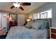 Spacious main bedroom featuring stained glass windows, decorative ceiling fan and a large dresser at 1430 Normandy Park Oaks Dr # 9, Clearwater, FL 33756