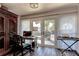 Bright office space with a desk, chair, armoire, and sliding glass doors to the outside patio at 1430 Normandy Park Oaks Dr # 9, Clearwater, FL 33756
