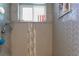 Detailed shot of the shower featuring decorative gray tile and a window for natural light at 1430 Normandy Park Oaks Dr # 9, Clearwater, FL 33756