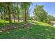 Expansive backyard with mature trees and waterfront views, providing a serene and private setting at 14727 Tudor Chase Dr, Tampa, FL 33626