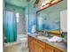 Unique bathroom featuring beautiful mural, wood cabinets, tile floors and a shower/tub combo at 14727 Tudor Chase Dr, Tampa, FL 33626