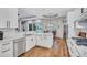 Bright kitchen with white cabinets, granite countertops, stainless steel appliances, and view to the pool at 14727 Tudor Chase Dr, Tampa, FL 33626