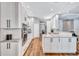 Modern kitchen with white cabinets, granite countertops, stainless steel appliances, and wood flooring at 14727 Tudor Chase Dr, Tampa, FL 33626