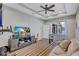 Living room with striped floors, a tv, a foosball table, and a comfortable seating area at 14727 Tudor Chase Dr, Tampa, FL 33626