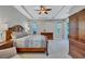 Spacious main bedroom with a tray ceiling, ceiling fan, carpet floors, and lots of natural light at 14727 Tudor Chase Dr, Tampa, FL 33626