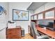 Home office with wood floors, built-in shelving, a modern computer setup, and a world map at 14727 Tudor Chase Dr, Tampa, FL 33626