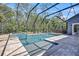 Pool area featuring a jacuzzi, lounge chairs, brick floors, and a screened-in patio at 14727 Tudor Chase Dr, Tampa, FL 33626
