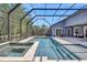Screened-in pool area with a spa and luxurious patio area, great for outdoor relaxation and entertainment at 14727 Tudor Chase Dr, Tampa, FL 33626