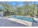 Pool area featuring a jacuzzi, lounge chairs, brick floors, and a screened-in patio at 14727 Tudor Chase Dr, Tampa, FL 33626