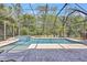 Pool area featuring a jacuzzi, lounge chairs, brick floors, and a screened-in patio at 14727 Tudor Chase Dr, Tampa, FL 33626