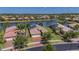 A high angle aerial shows attractive homes with well-manicured lawns in a quiet lakeside community at 16139 Coquina Bay Ln, Wimauma, FL 33598