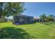 Spacious backyard featuring a screened lanai and a well-manicured lawn, perfect for outdoor enjoyment at 16139 Coquina Bay Ln, Wimauma, FL 33598