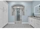 Modern bathroom boasts an oversized glass shower and large vanity with granite counters and decorative tile flooring at 16139 Coquina Bay Ln, Wimauma, FL 33598