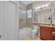 Well-lit bathroom featuring a tiled shower-tub, vanity with granite counters, and ample space at 16139 Coquina Bay Ln, Wimauma, FL 33598