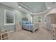 Comfortable bedroom featuring tray ceiling, bright windows and neutral color palette at 16139 Coquina Bay Ln, Wimauma, FL 33598