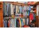 Organized walk-in closet with ample shelving and hanging space for clothing and accessories at 16139 Coquina Bay Ln, Wimauma, FL 33598