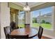 Cozy dining area with backyard view and stylish light fixture at 16139 Coquina Bay Ln, Wimauma, FL 33598