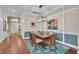 Dining room with custom trim work and a designer chandelier, blending formal elegance with contemporary design at 16139 Coquina Bay Ln, Wimauma, FL 33598