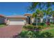 Charming curb appeal with manicured lawn and lush tropical landscaping framing this lovely single Gathering home at 16139 Coquina Bay Ln, Wimauma, FL 33598