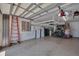 Organized garage with a ladder, electrical panels, Tesla Powerwalls, and bicycles at 16139 Coquina Bay Ln, Wimauma, FL 33598