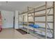 Spacious garage with shelving units, storage space, and an epoxy floor at 16139 Coquina Bay Ln, Wimauma, FL 33598
