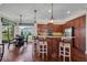 Eat-in kitchen featuring a large island, pendant lighting, and stainless steel appliances at 16139 Coquina Bay Ln, Wimauma, FL 33598