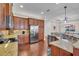 Spacious kitchen with stainless steel appliances, granite counters, and wooden cabinetry at 16139 Coquina Bay Ln, Wimauma, FL 33598