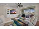 Cozy living room with built-in shelving, a ceiling fan, and sliding glass doors overlooking the outdoor space at 16139 Coquina Bay Ln, Wimauma, FL 33598