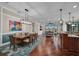 Open concept living space featuring an eat-in kitchen island and formal dining area with lovely hardwood floors at 16139 Coquina Bay Ln, Wimauma, FL 33598
