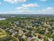 Panoramic aerial view of a residential neighborhood featuring mature trees and several small lakes on a sunny day at 16910 Equestrian Trl, Odessa, FL 33556