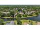 Beautiful aerial view showcases homes along the water in a quiet neighborhood surrounded by mature trees at 16910 Equestrian Trl, Odessa, FL 33556