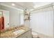 This bathroom has a large mirror, granite countertop, shelves, and a shower curtain at 16910 Equestrian Trl, Odessa, FL 33556