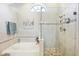 Bright bathroom with a large soaking tub and a separate glass enclosed shower at 16910 Equestrian Trl, Odessa, FL 33556
