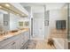 Bright bathroom features double sinks, granite countertops, and modern fixtures at 16910 Equestrian Trl, Odessa, FL 33556