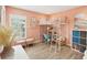 Cozy bedroom featuring a white metal loft bed, wood floors, and salmon-colored walls at 16910 Equestrian Trl, Odessa, FL 33556