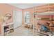 Bedroom with wood floor and salmon walls, featuring a loft bed and white double door closet at 16910 Equestrian Trl, Odessa, FL 33556