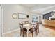 Cozy dining area adjacent to a living area and features tile floors and glass doors at 16910 Equestrian Trl, Odessa, FL 33556