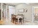 Charming dining area featuring tile floors, an inviting table set, and ample natural light at 16910 Equestrian Trl, Odessa, FL 33556