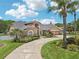 Stunning home boasts lush landscaping, a circular driveway, and a grand entrance, showcasing elegance and curb appeal at 16910 Equestrian Trl, Odessa, FL 33556