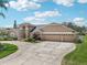 Elegant home with a well-maintained lawn, mature landscaping, and a large three-car garage, combining style and convenience at 16910 Equestrian Trl, Odessa, FL 33556