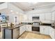 Well-equipped kitchen featuring an island, stainless steel appliances, and modern finishes at 16910 Equestrian Trl, Odessa, FL 33556