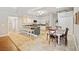Well-lit open kitchen and dining area with granite countertops, and skylight at 16910 Equestrian Trl, Odessa, FL 33556