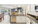 Open concept kitchen features stainless steel appliances, granite counters, and a breakfast bar at 16910 Equestrian Trl, Odessa, FL 33556