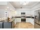Modern kitchen boasts stainless steel appliances, including a microwave, oven, and refrigerator at 16910 Equestrian Trl, Odessa, FL 33556