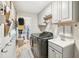 Functional laundry room with white cabinetry, modern washer/dryer, and practical organization at 16910 Equestrian Trl, Odessa, FL 33556