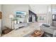 Bright living area boasting travertine floors, a decorative ladder, stylish furniture, and views of the open floor plan at 16910 Equestrian Trl, Odessa, FL 33556