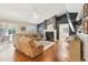 Cozy living room featuring hardwood floors, a fireplace and TV at 16910 Equestrian Trl, Odessa, FL 33556