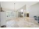 Open living room with stone floors, clerestory windows and natural light at 16910 Equestrian Trl, Odessa, FL 33556