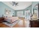 Serene main bedroom with hardwood floors, ceiling fan, and french doors to the pool at 16910 Equestrian Trl, Odessa, FL 33556